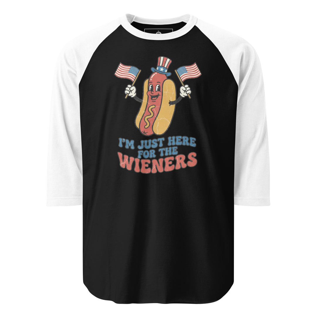 I'm Just Here For The Wieners funny 4th of July BBQ tee — patriotic hot dog character in Uncle Sam hat waving two American flags, retro groovy lettering on white tee