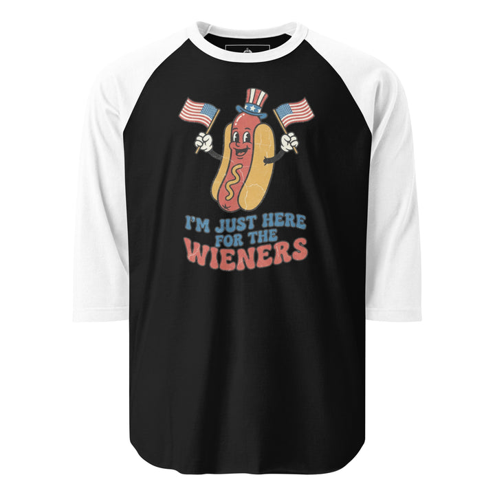 I'm Just Here For The Wieners funny 4th of July BBQ tee — patriotic hot dog character in Uncle Sam hat waving two American flags, retro groovy lettering on white tee