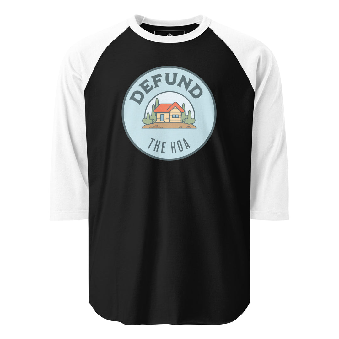 Defund The HOA funny suburban graphic tee — circular badge with cartoon house and trees and DEFUND THE HOA text
