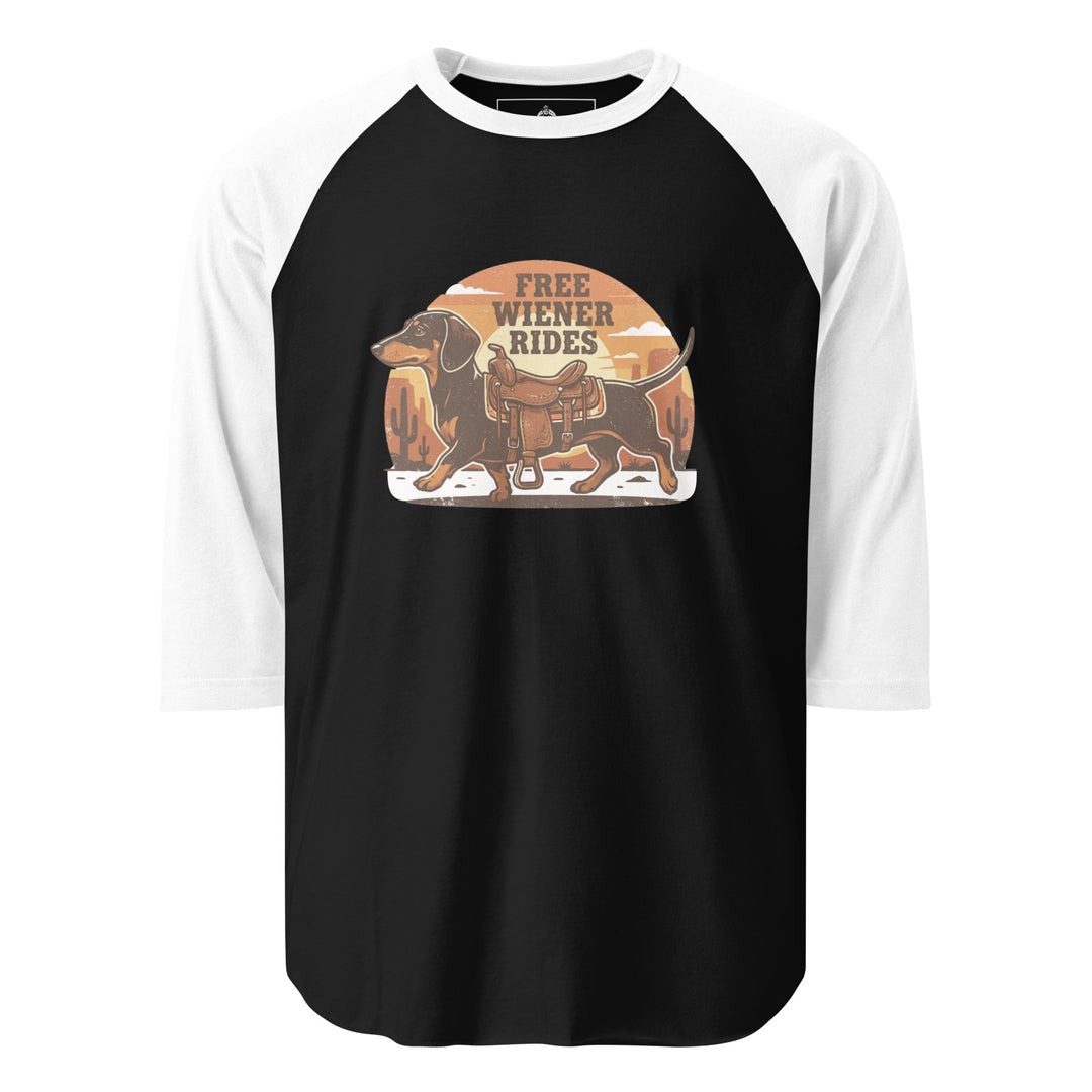 Free Wiener Rides — a dachshund wearing a western saddle in a desert sunset, captioned Free Wiener Rides, printed on a 3/4 sleeve raglan shirt.