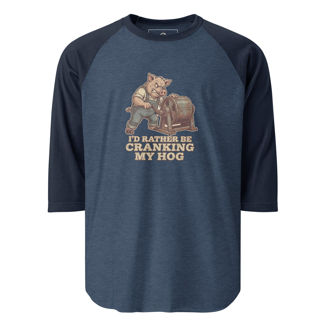 I'd Rather Be Cranking My Hog — an overalls-wearing pig cranking an old hand-crank machine, captioned I'd Rather Be Cranking My Hog, printed on a 3/4 sleeve raglan shirt.