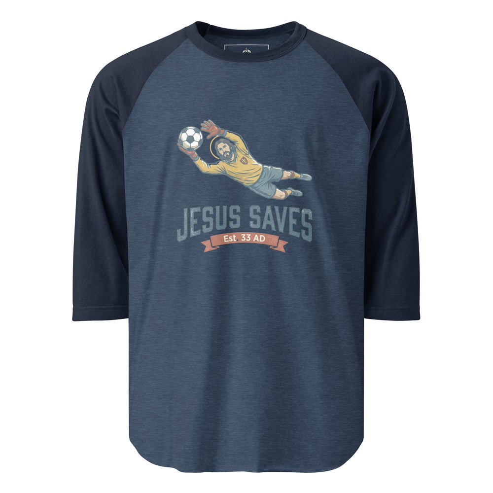 Jesus Saves — Jesus as a soccer goalkeeper diving to catch the ball with a halo, captioned Jesus Saves Est 33 AD, printed on a 3/4 sleeve raglan shirt.