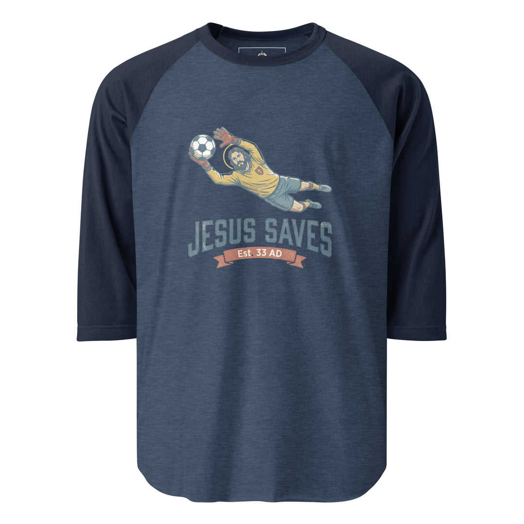Jesus Saves — Jesus as a soccer goalkeeper diving to catch the ball with a halo, captioned Jesus Saves Est 33 AD, printed on a 3/4 sleeve raglan shirt.
