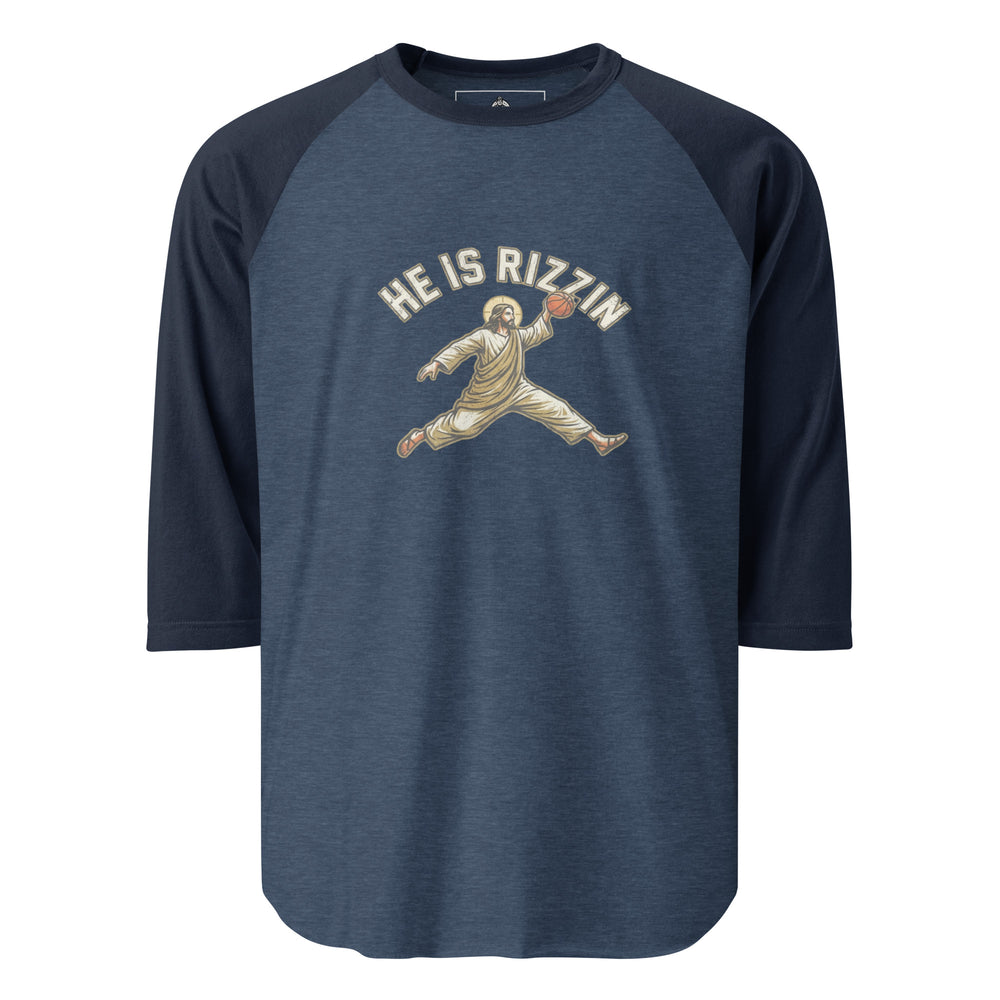 He Is Rizzin — Jesus doing a Jordan-style basketball dunk with a halo, captioned He Is Rizzin, printed on a 3/4 sleeve raglan shirt.