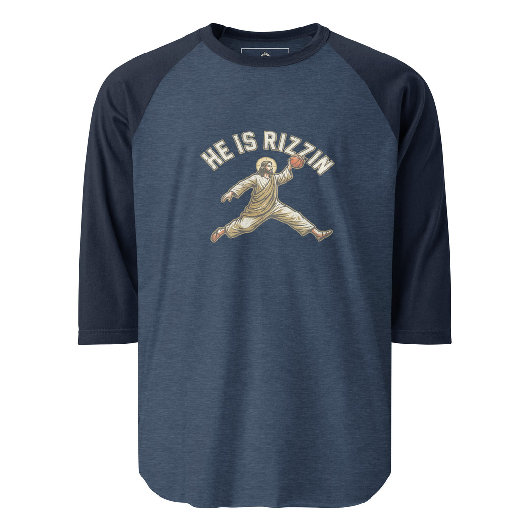 He Is Rizzin — Jesus doing a Jordan-style basketball dunk with a halo, captioned He Is Rizzin, printed on a 3/4 sleeve raglan shirt.