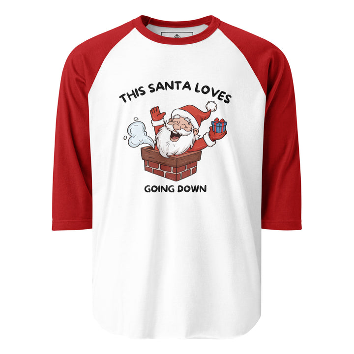 This Santa Loves Going Down — a cheerful Santa popping out of a chimney holding a gift, captioned This Santa Loves Going Down, printed on a 3/4 sleeve raglan shirt.