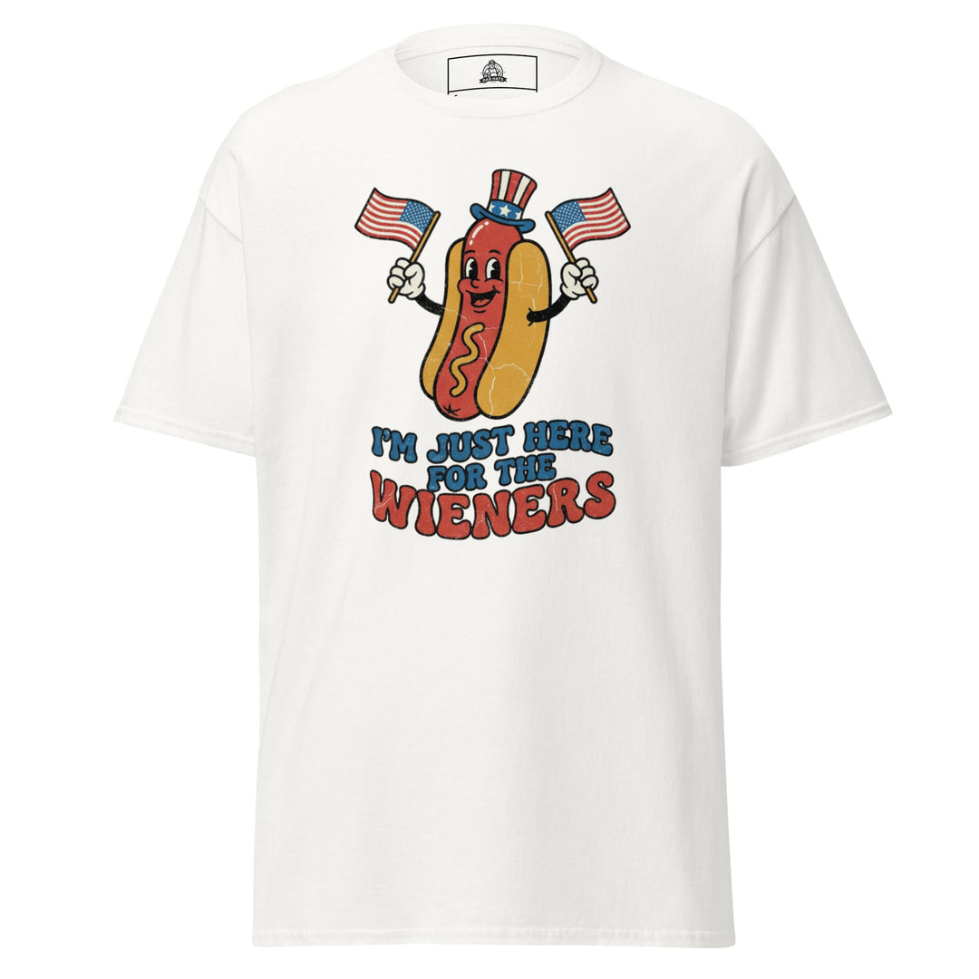 I'm Just Here For The Wieners funny 4th of July BBQ tee — patriotic hot dog character in Uncle Sam hat waving two American flags, retro groovy lettering on white tee