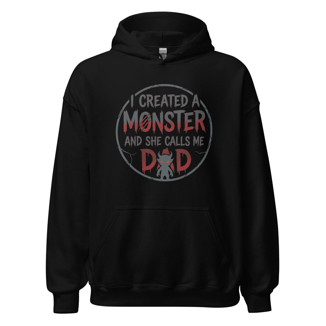 I Created A Monster And She Calls Me Dad funny graphic tee — horror style lettering with a small devil monster forming the A in DAD