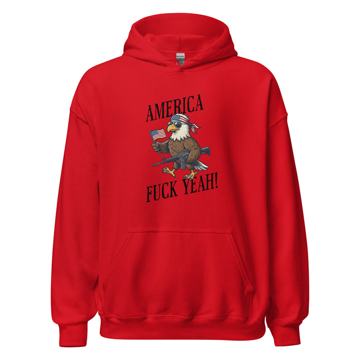 America Fuck Yeah — a bald eagle in a USA flag bandana and sunglasses holding an American flag and a rifle, with the words America Fuck Yeah, printed on a unisex hoodie.