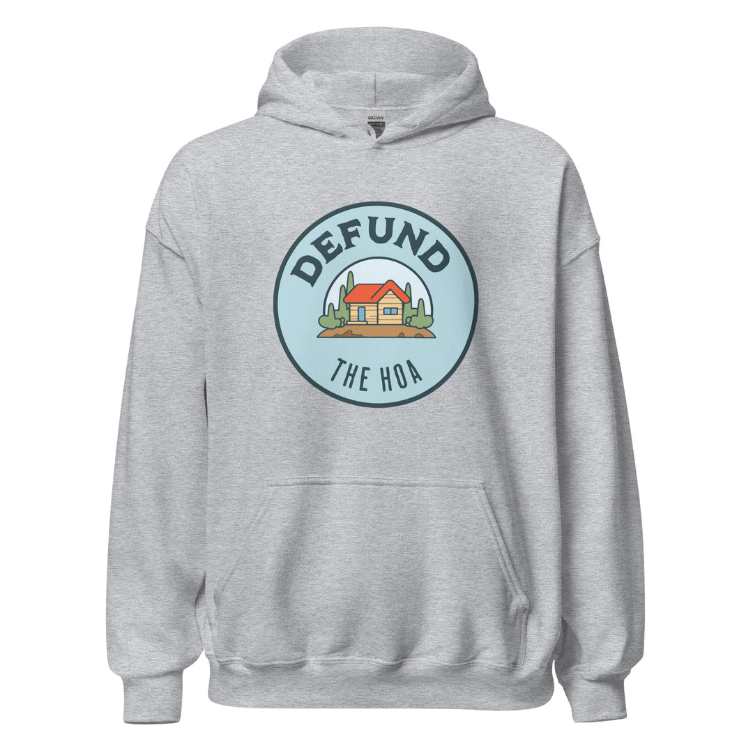 Defund The HOA funny suburban graphic tee — circular badge with cartoon house and trees and DEFUND THE HOA text