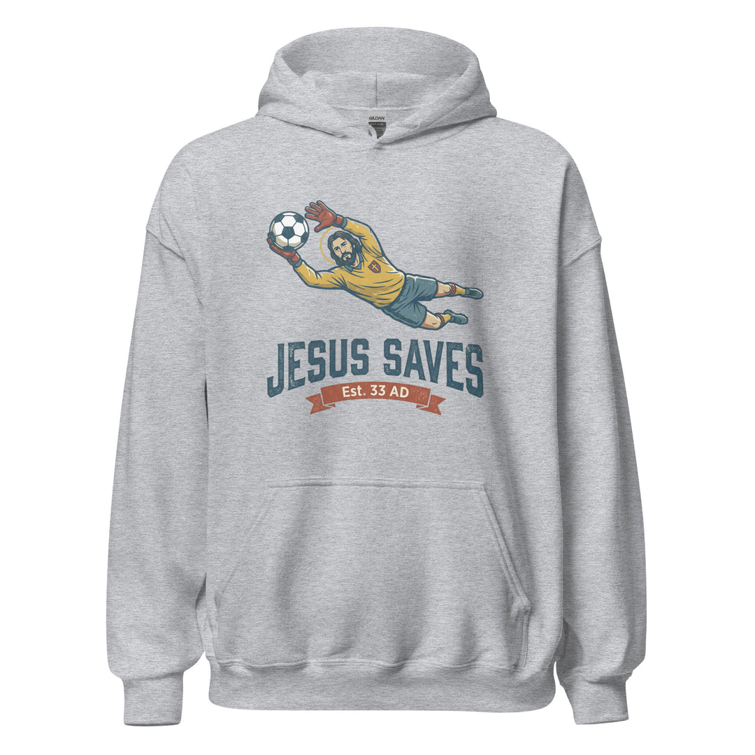 Jesus Saves — Jesus as a soccer goalkeeper diving to catch the ball with a halo, captioned Jesus Saves Est 33 AD, printed on a unisex hoodie.