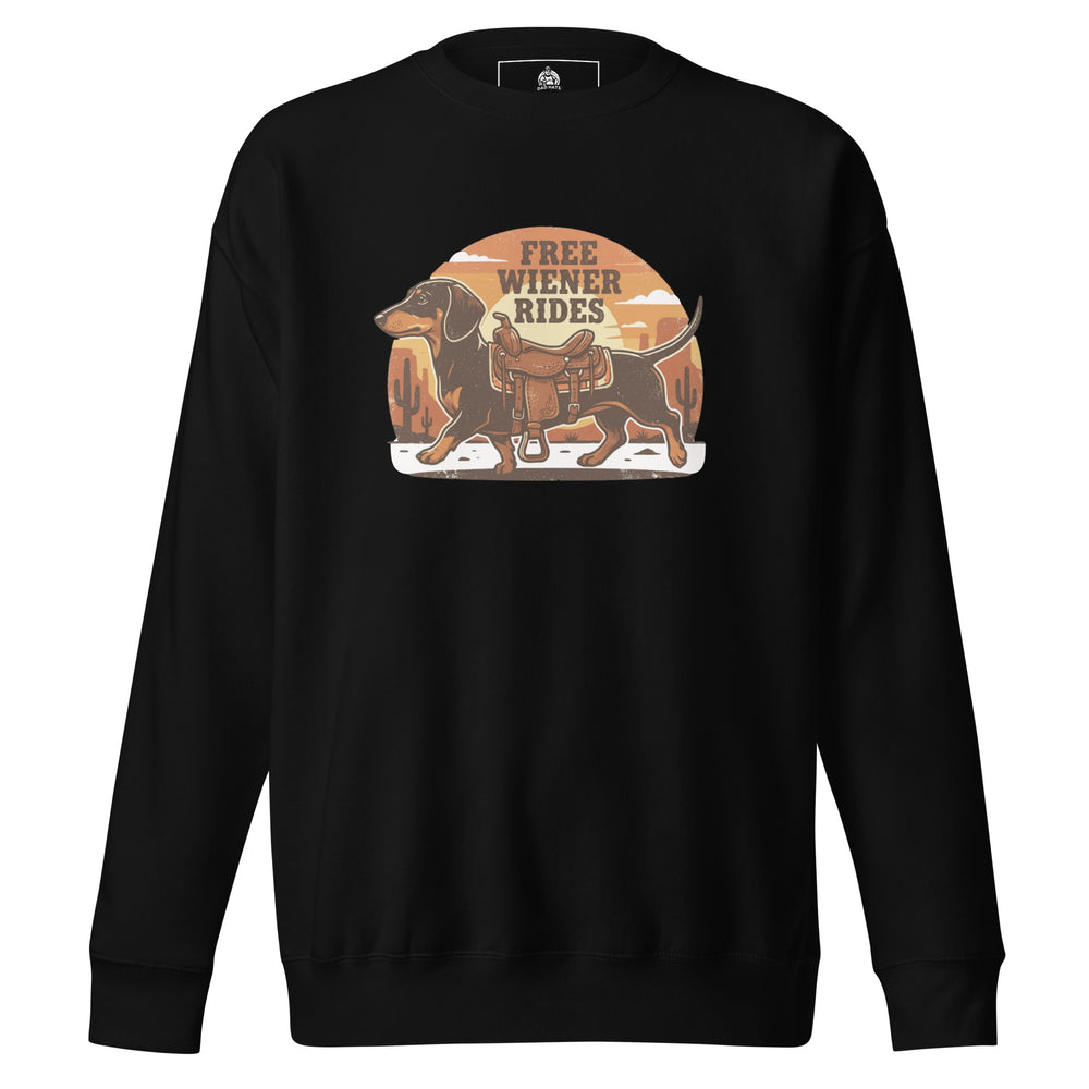 Free Wiener Rides — a dachshund wearing a western saddle in a desert sunset, captioned Free Wiener Rides, printed on a unisex sweatshirt.