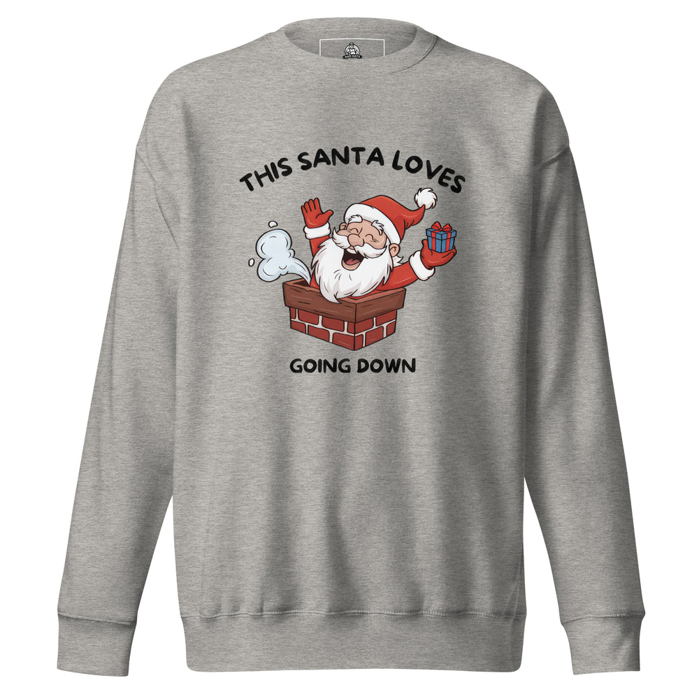 This Santa Loves Going Down — a cheerful Santa popping out of a chimney holding a gift, captioned This Santa Loves Going Down, printed on a unisex sweatshirt.