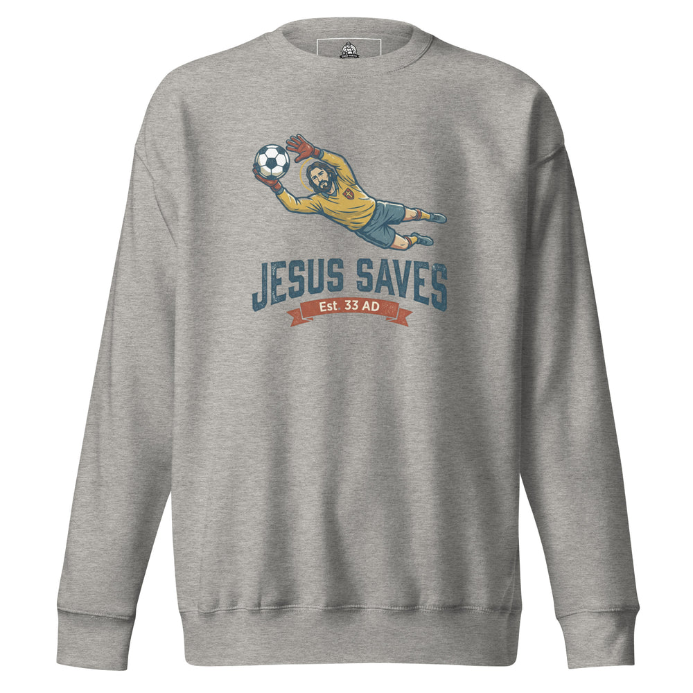 Jesus Saves — Jesus as a soccer goalkeeper diving to catch the ball with a halo, captioned Jesus Saves Est 33 AD, printed on a unisex sweatshirt.