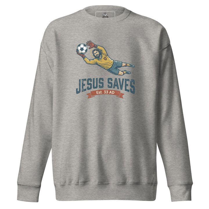 Jesus Saves — Jesus as a soccer goalkeeper diving to catch the ball with a halo, captioned Jesus Saves Est 33 AD, printed on a unisex sweatshirt.