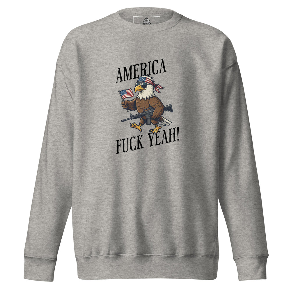 America Fuck Yeah — a bald eagle in a USA flag bandana and sunglasses holding an American flag and a rifle, with the words America Fuck Yeah, printed on a unisex sweatshirt.