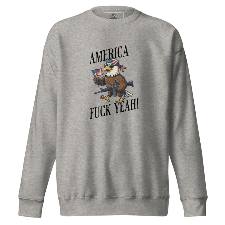 America Fuck Yeah — a bald eagle in a USA flag bandana and sunglasses holding an American flag and a rifle, with the words America Fuck Yeah, printed on a unisex sweatshirt.