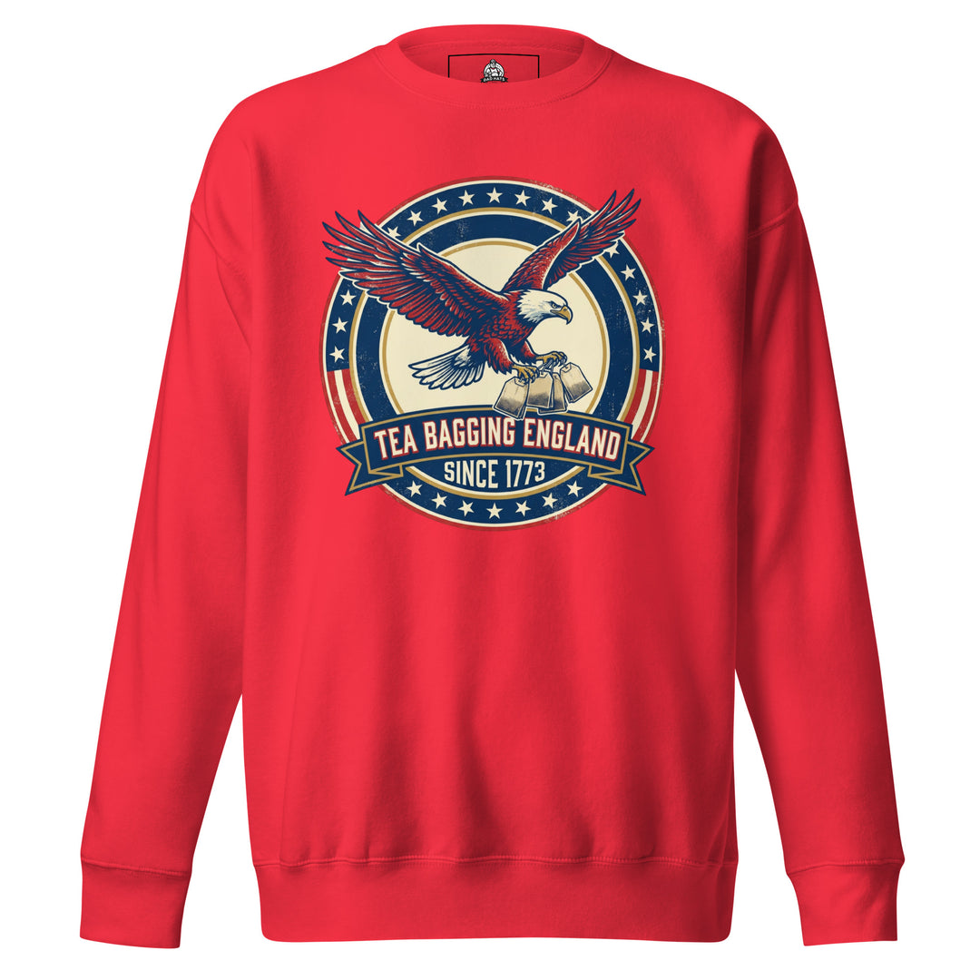 Tea Bagging England Since 1773 funny 4th of July graphic tee — bald eagle carrying tea bags inside patriotic stars and stripes ring