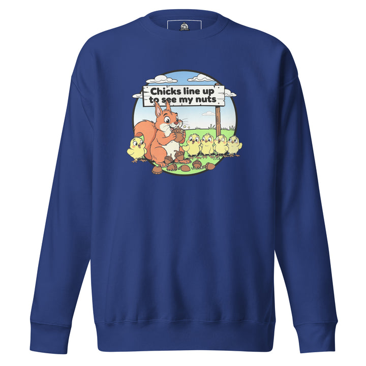 Chicks Line Up To See My Nuts — a cartoon squirrel holding acorns while baby chicks line up behind a sign reading Chicks Line Up To See My Nuts, printed on a unisex sweatshirt.